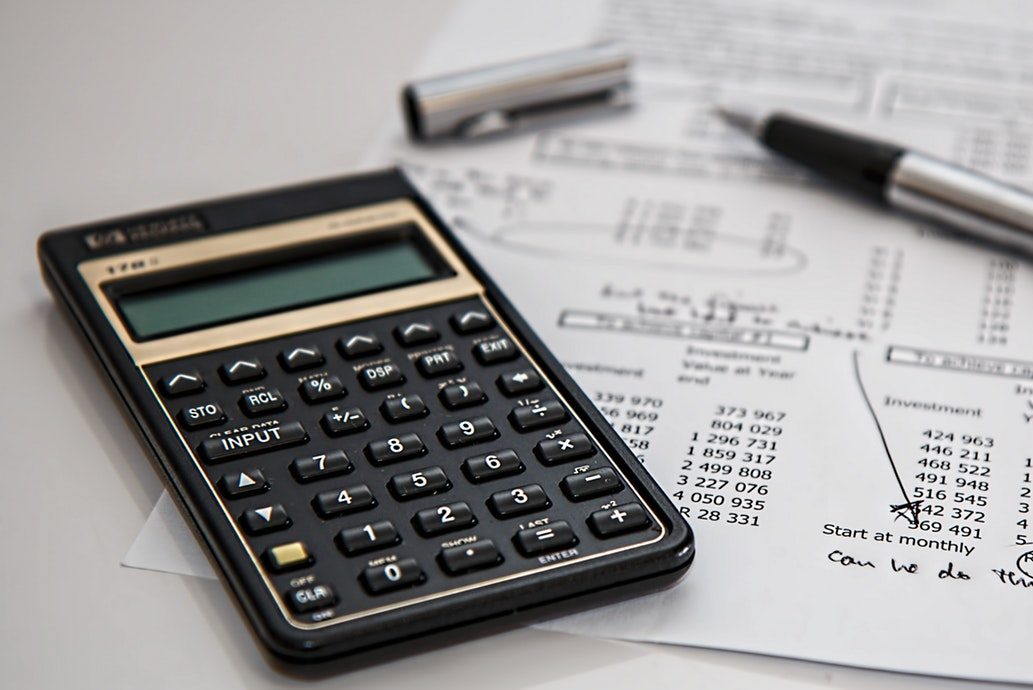 cropped-black-calculator-near-ballpoint-pen-on-white-printed-paper-53621.jpg